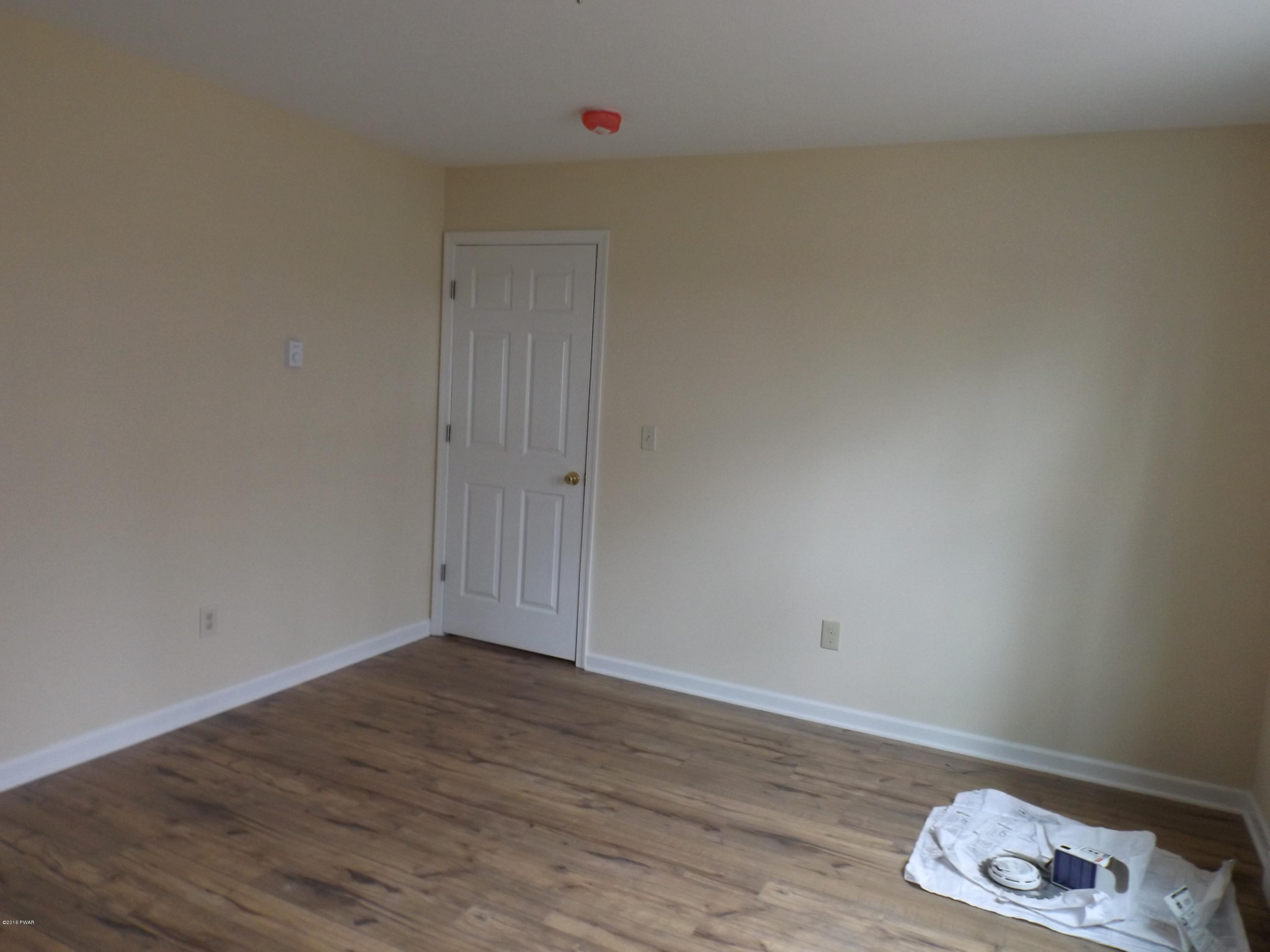 109 Keystone Court Dingmans Ferry, PA 18328 - Photo 6 of 18 a view of an empty room and wooden floor