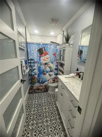 a view of a kitchen with a sink and refrigerator