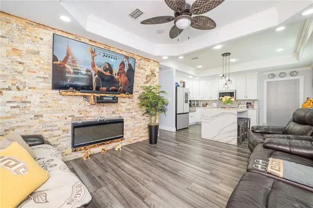 a living room with furniture fireplace and flat screen tv