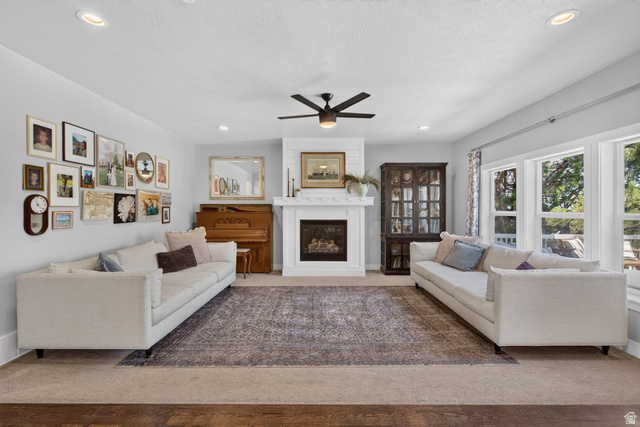 1263 East 1200th South Springville, UT 84663 - Photo 31 of 60 Living area featuring a fireplace with a white mantel, shiplap accent wall, and recessed lighting