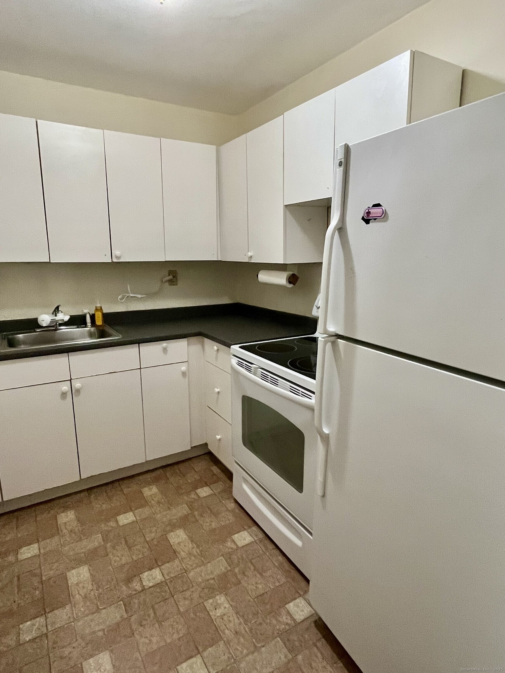 100 York Street, Unit 9B New Haven, CT 06511 - Photo 12 of 17 a kitchen with granite countertop white cabinets and white appliances