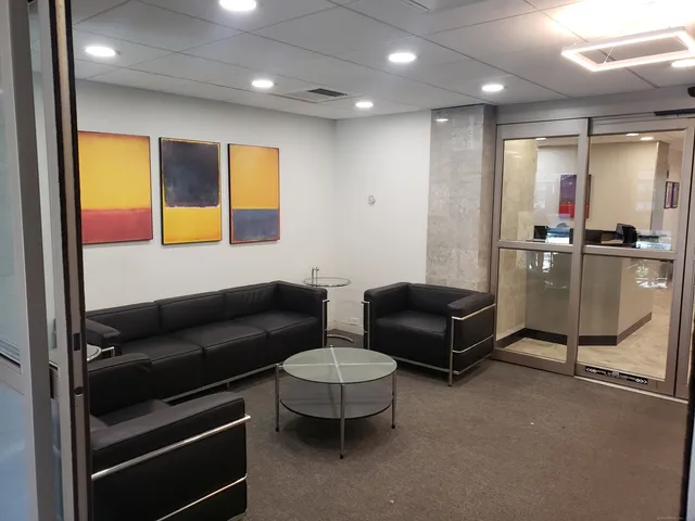 a living room with furniture a ceiling fan and a window