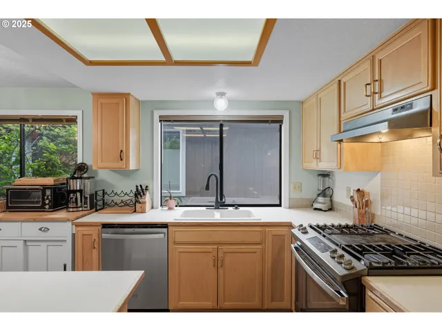 a kitchen with a sink stove and cabinets