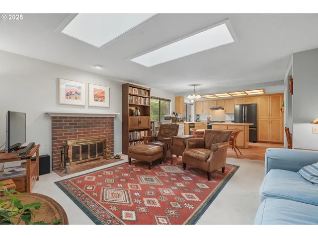 a living room with furniture a rug and a fireplace