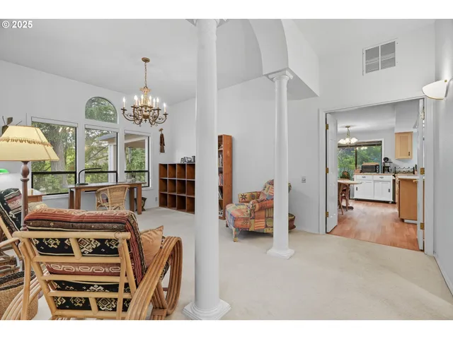 a living room with furniture and a chandelier