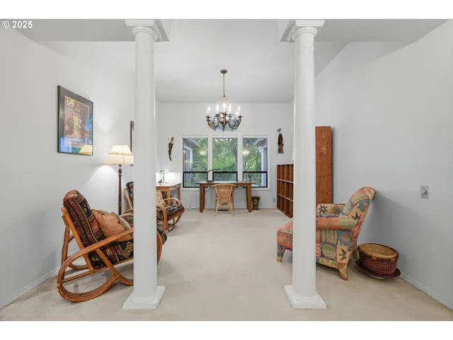 a living room with furniture a chandelier and a large mirror