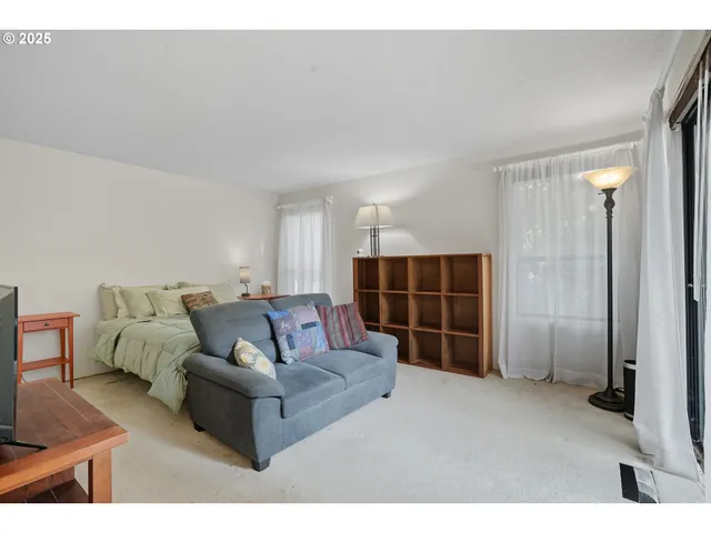a living room with furniture and a walk in closet