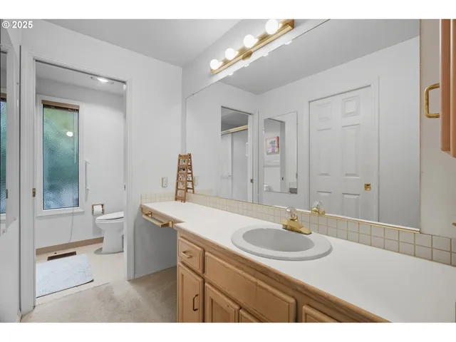 a bathroom with a sink a toilet a shower and a mirror