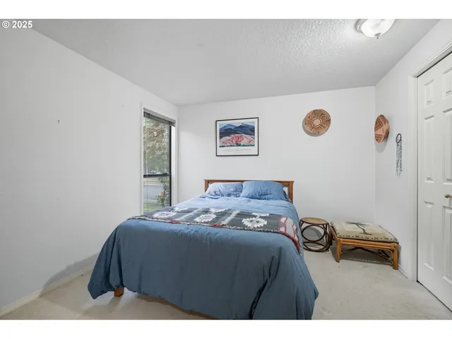 a bedroom with a bed and a table