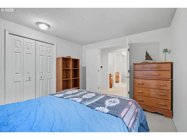 a bedroom with a bed and a closet