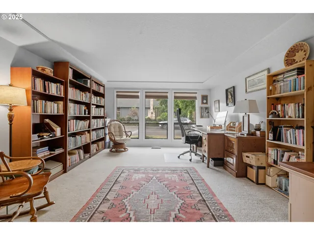 a living room with furniture and a book shelf