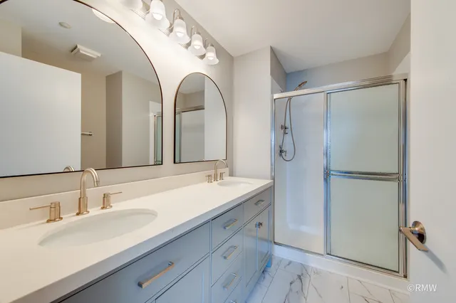 a bathroom with a double vanity sink mirror and double