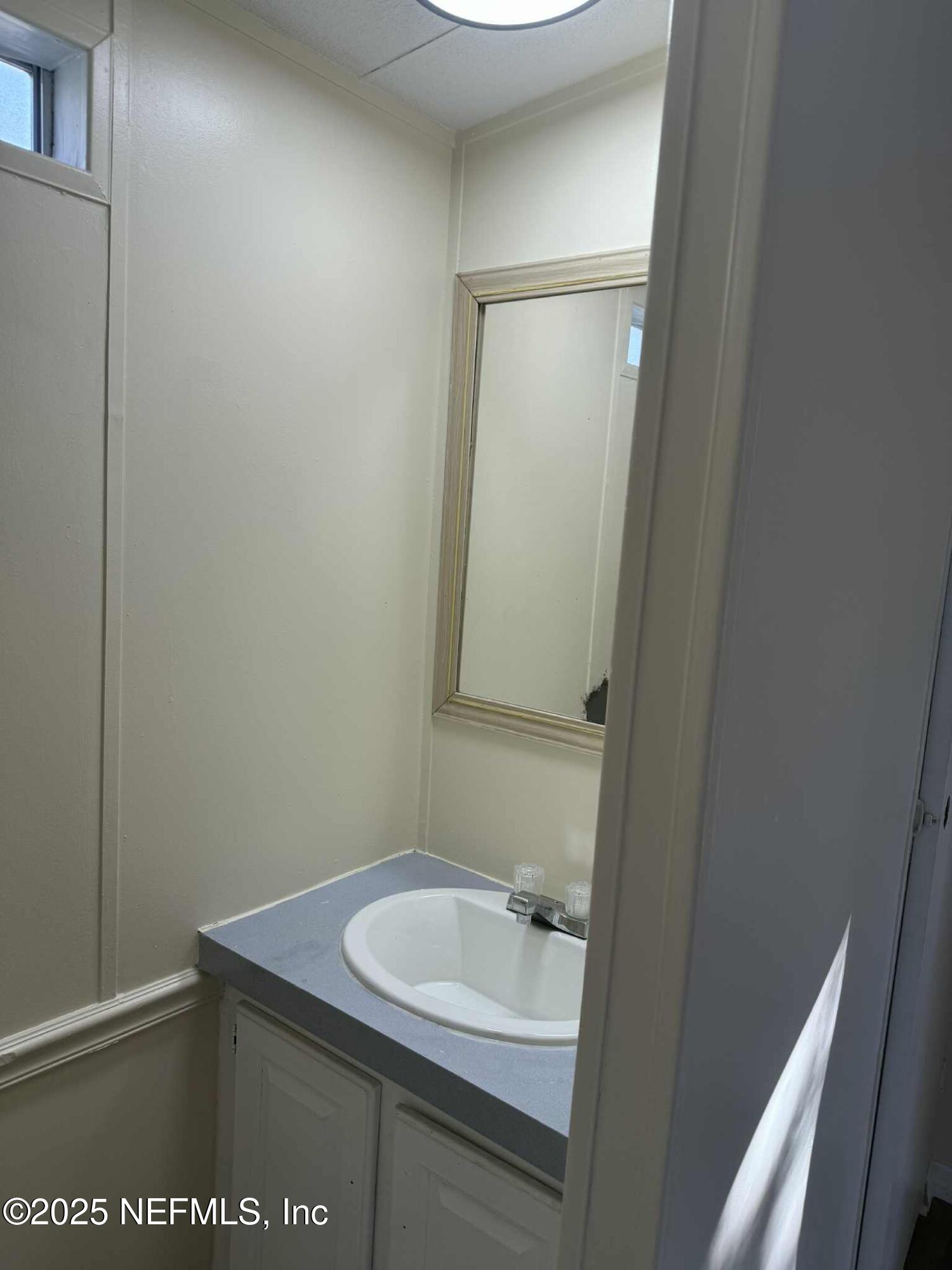 550 Interlachen Boulevard Interlachen, FL 32148 - Photo 15 of 15 a bathroom with a sink and a mirror