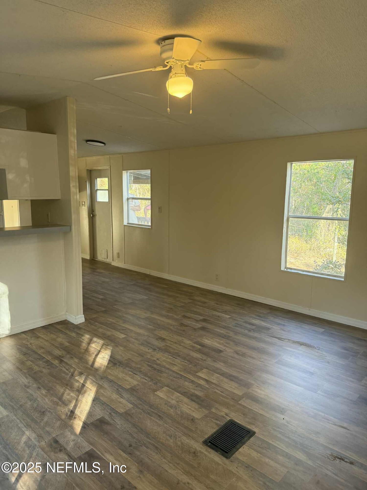 550 Interlachen Boulevard Interlachen, FL 32148 - Photo 6 of 15 a view of an empty room with window and wooden floor
