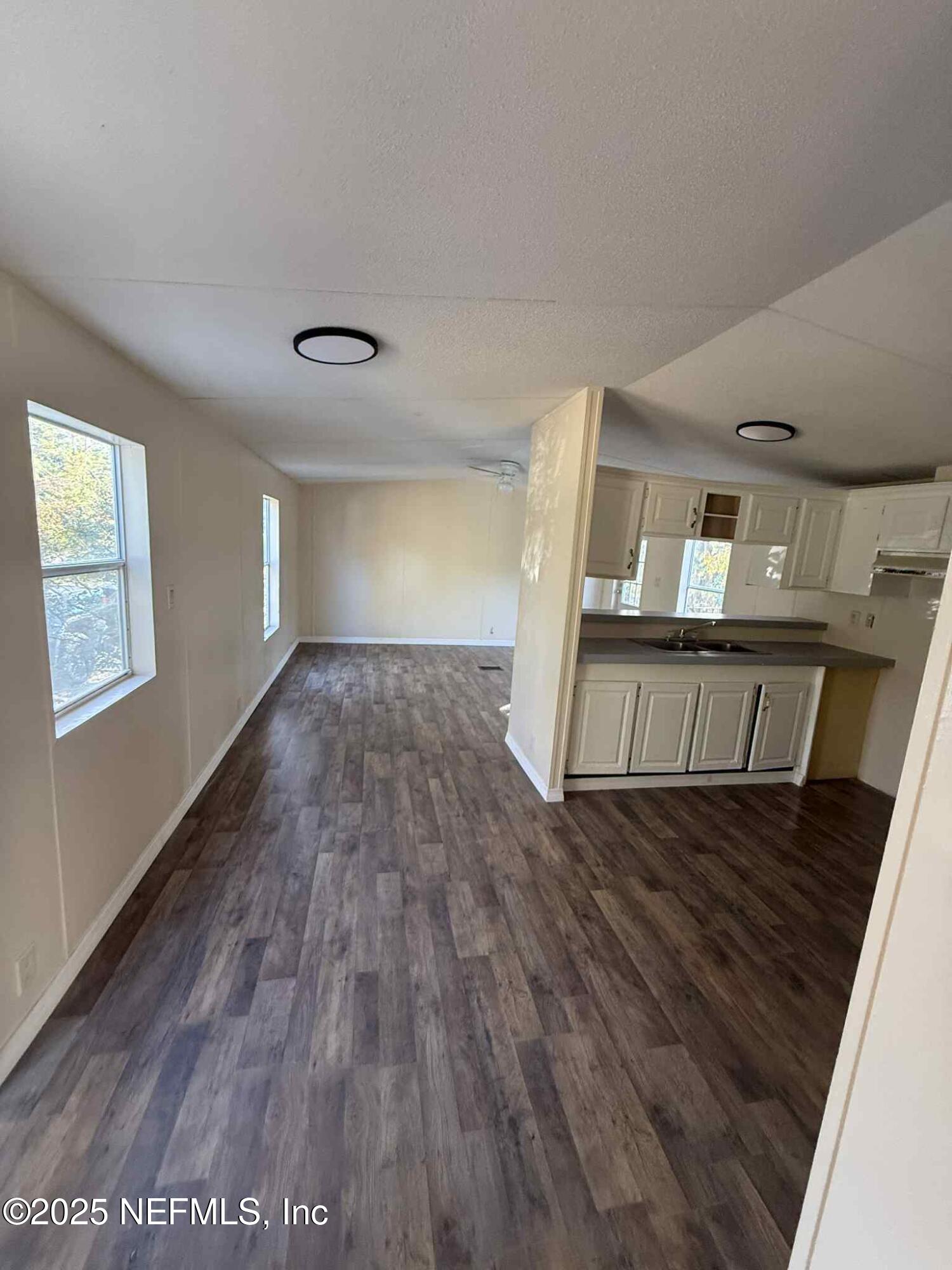 550 Interlachen Boulevard Interlachen, FL 32148 - Photo 9 of 15 a view of an empty room with wooden floor and a window