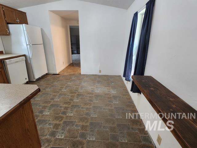 1220 North 4th Street Parma, ID 83660 - Photo 15 of 23 Kitchen with stone finish flooring, white appliances, and light countertops