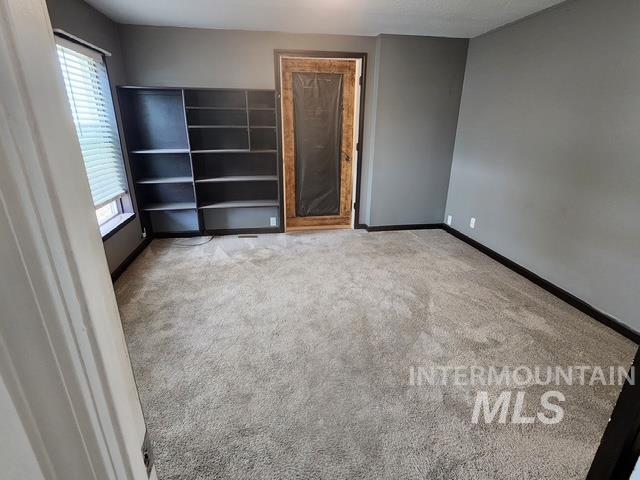 1220 North 4th Street Parma, ID 83660 - Photo 16 of 23 Unfurnished bedroom with light carpet and baseboards