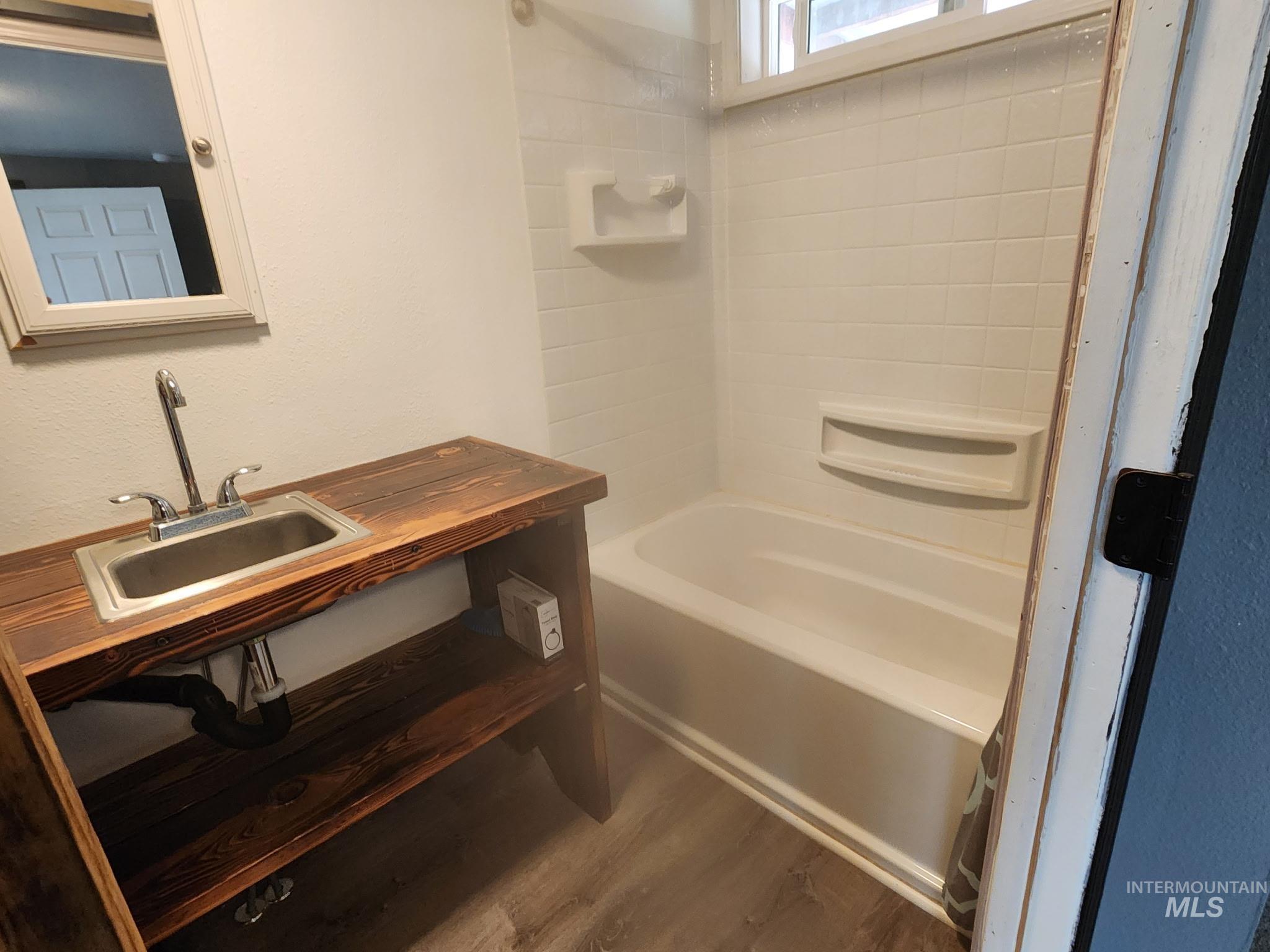1220 North 4th Street Parma, ID 83660 - Photo 19 of 23 Full bath with dark wood finished floors, vanity, and shower / bath combination