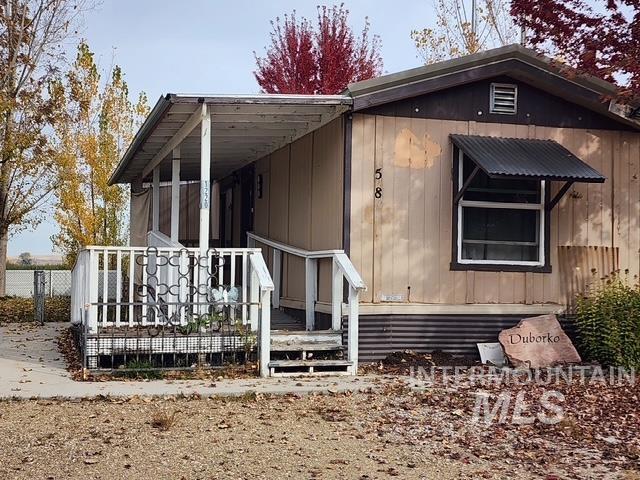 1220 North 4th Street Parma, ID 83660 - Photo 2 of 23 View of side of home featuring a wooden deck
