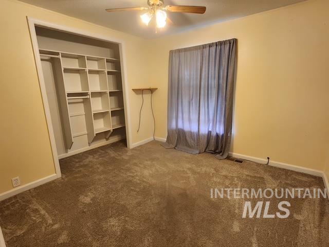1220 North 4th Street Parma, ID 83660 - Photo 21 of 23 Unfurnished bedroom with carpet flooring, ceiling fan, and a closet