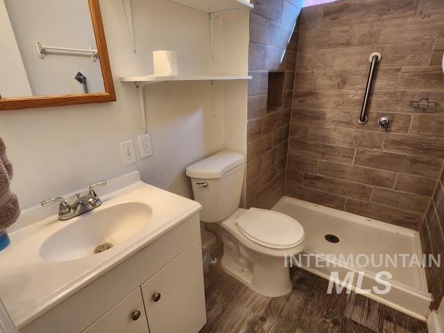 1220 North 4th Street Parma, ID 83660 - Photo 22 of 23 Full bath with vanity, dark wood-style floors, and a shower stall
