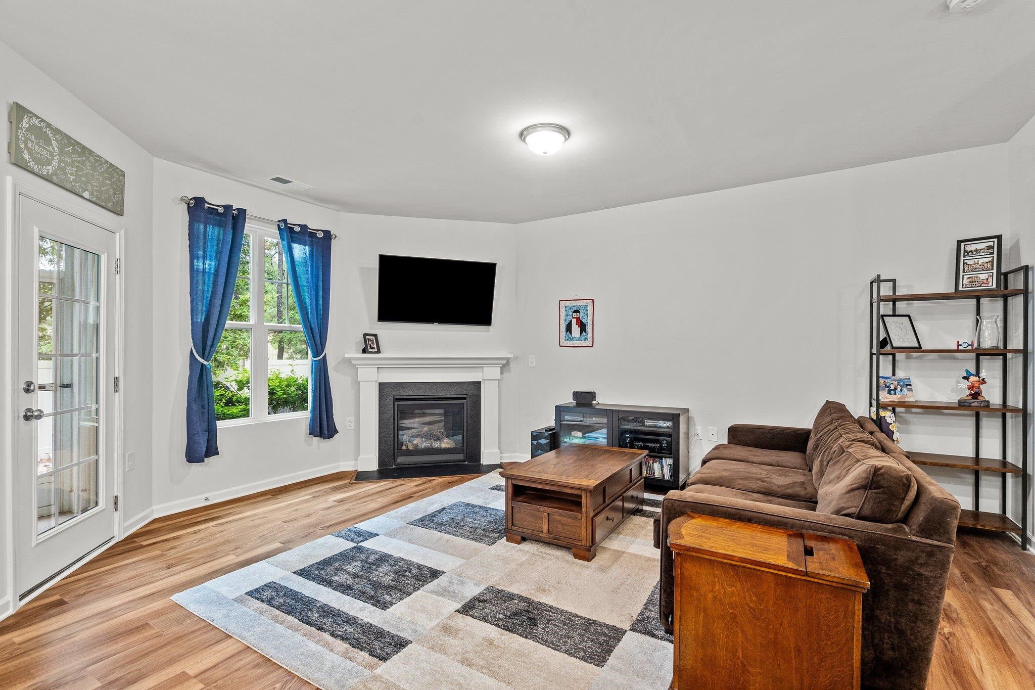 6085 Beale Loop Raleigh, NC 27616 - Photo 11 of 42 a living room with furniture a rug and a fireplace