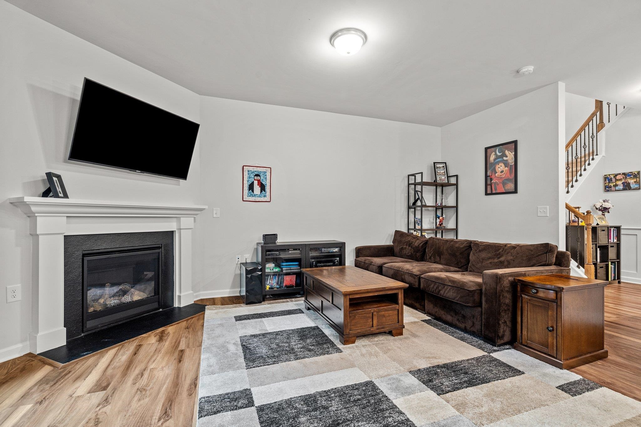 6085 Beale Loop Raleigh, NC 27616 - Photo 13 of 42 a living room with furniture a flat screen tv and a fireplace