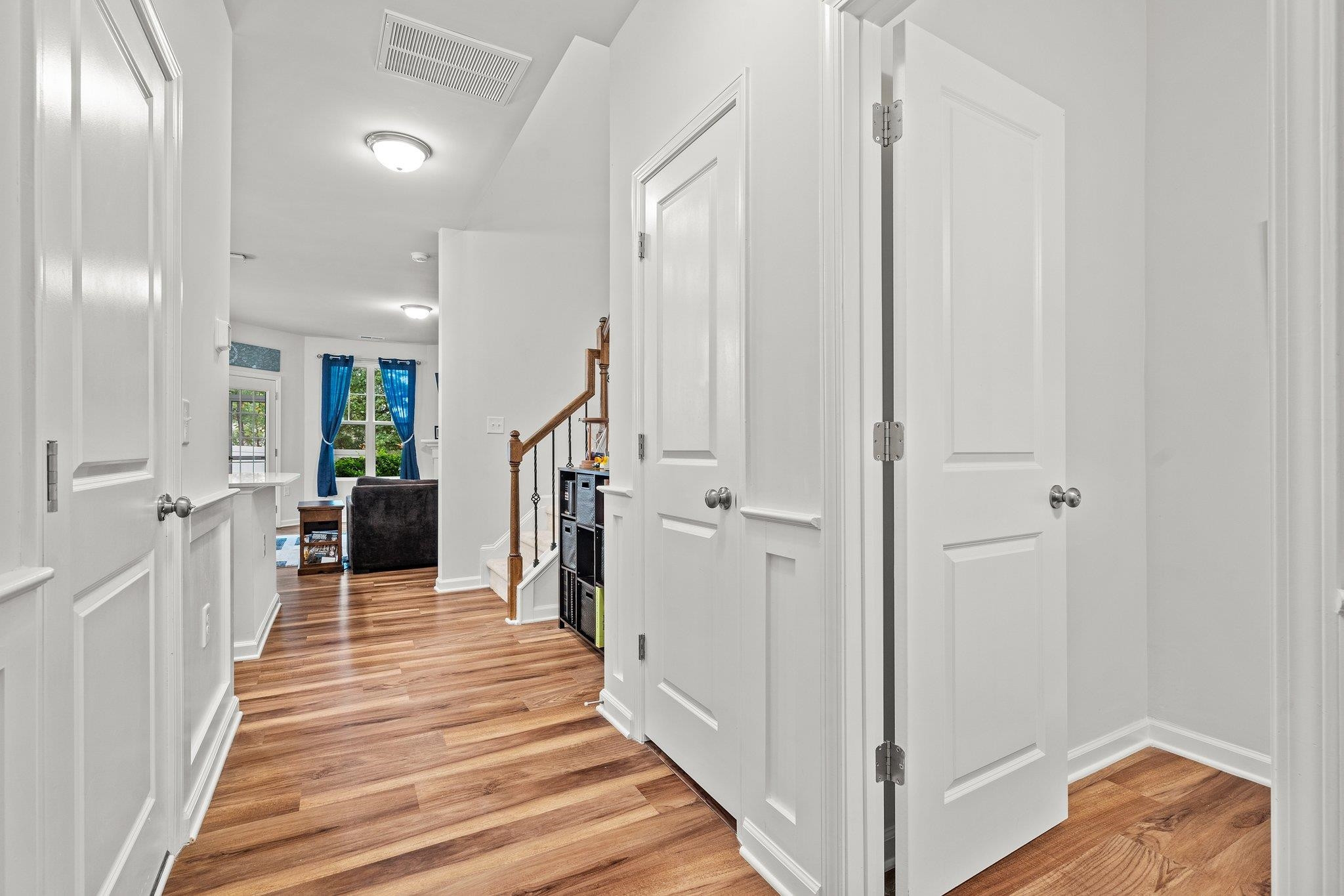 6085 Beale Loop Raleigh, NC 27616 - Photo 16 of 42 a view of a hallway with wooden floor and staircase