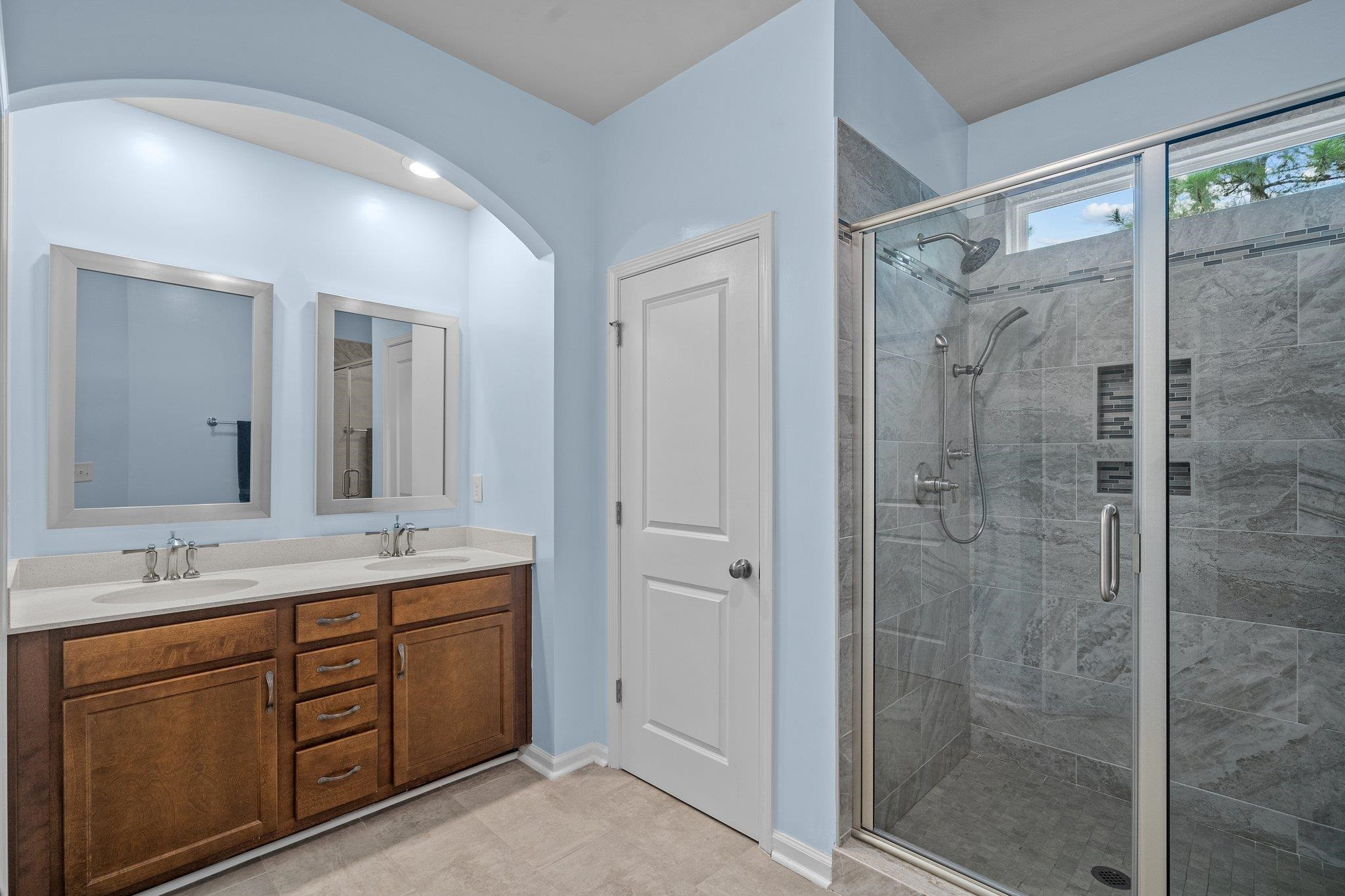 6085 Beale Loop Raleigh, NC 27616 - Photo 21 of 42 a bathroom with a shower sink and mirror