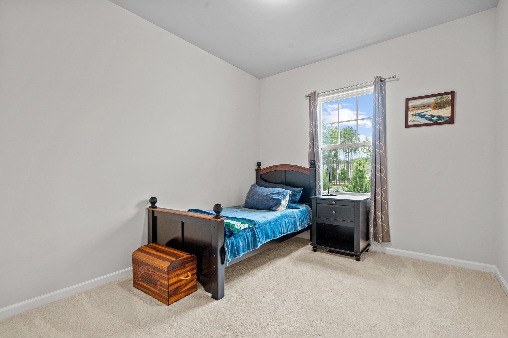 6085 Beale Loop Raleigh, NC 27616 - Photo 24 of 42 a bedroom with furniture and a window