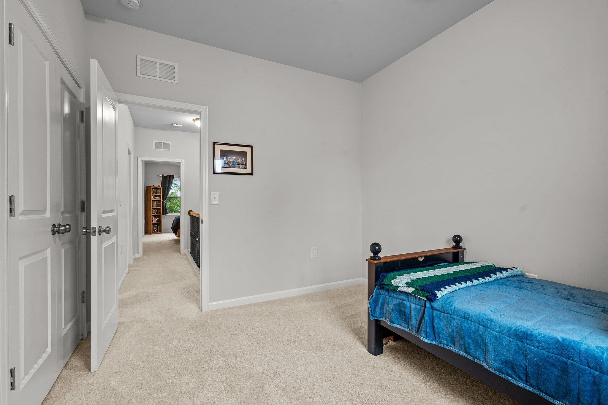 6085 Beale Loop Raleigh, NC 27616 - Photo 25 of 42 a bedroom with a bed and a table