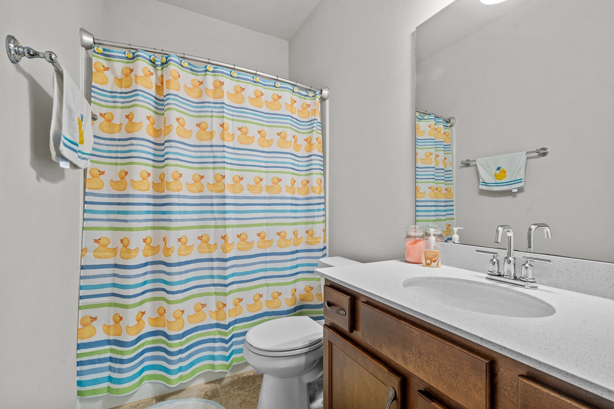 6085 Beale Loop Raleigh, NC 27616 - Photo 26 of 42 a bathroom with a sink a toilet and a shower curtain