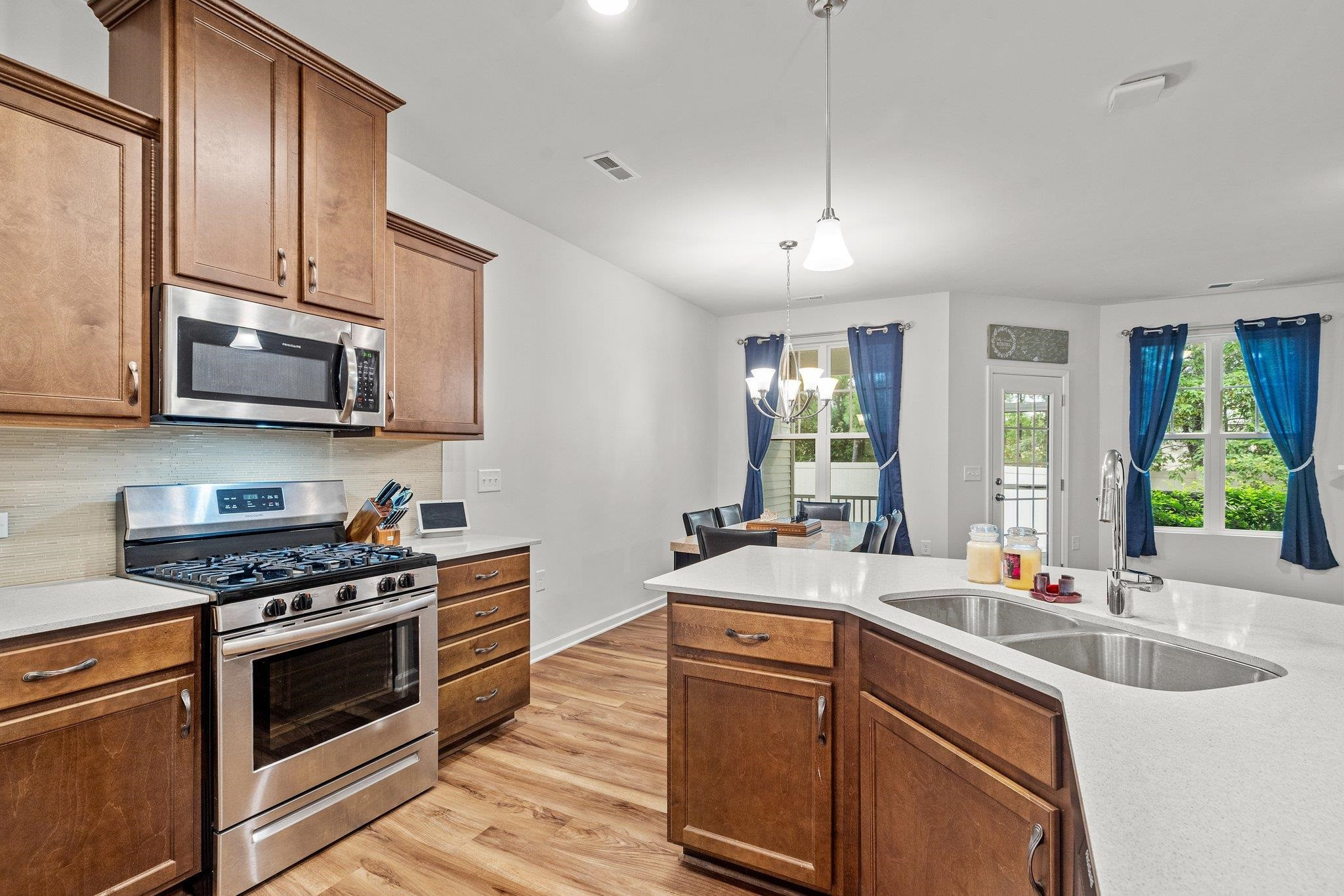 6085 Beale Loop Raleigh, NC 27616 - Photo 9 of 42 a kitchen with stainless steel appliances a sink stove and microwave