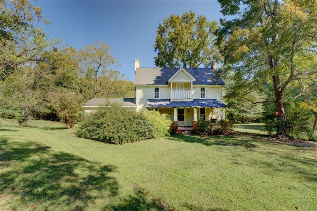 4018 Double Springs Road Southwest Monroe, GA 30656 - Photo 1 of 1 a front view of a house with a yard