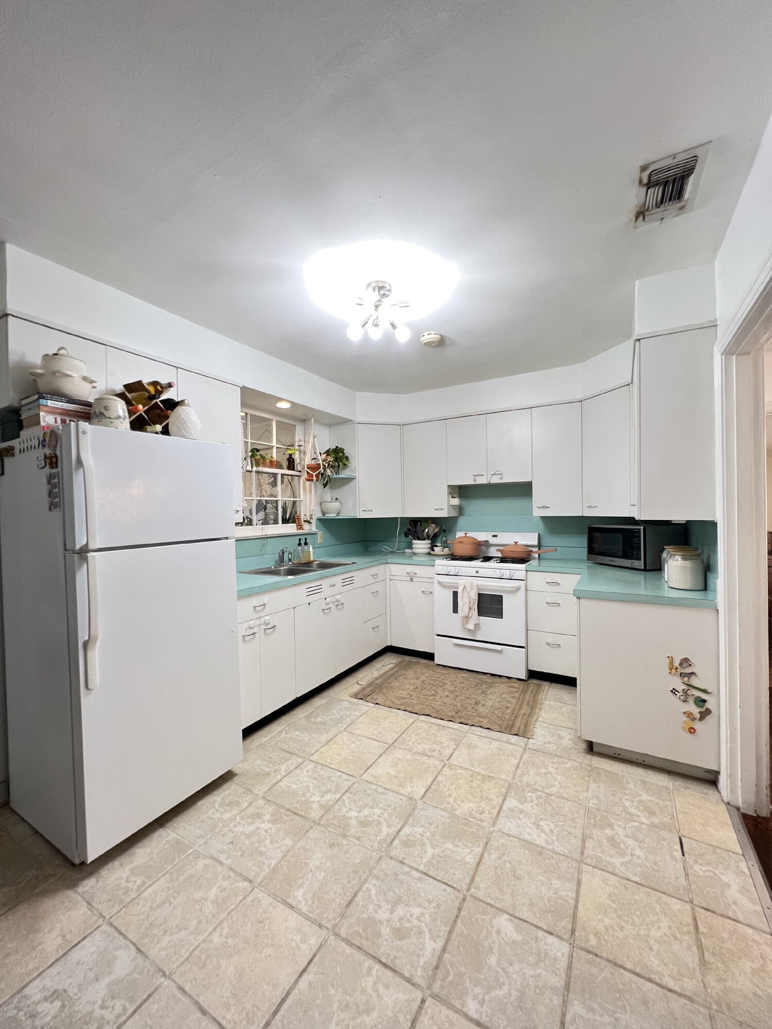 2111 23rd Street Lubbock, TX 79411 - Photo 5 of 15 a kitchen with a cabinets and white appliances