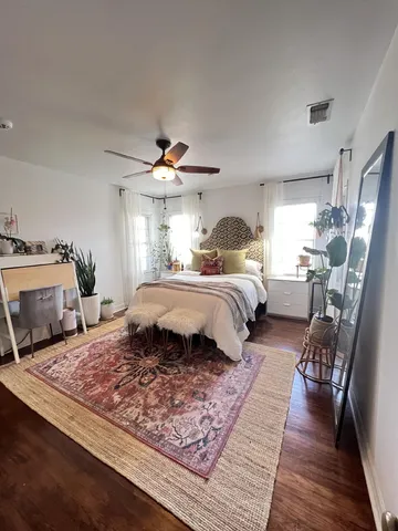 a bedroom with a large bed and a couch