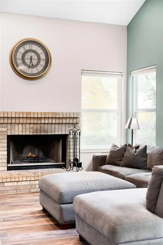 a living room with furniture a window and a fireplace