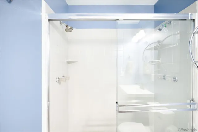 a bathroom with a glass shower door