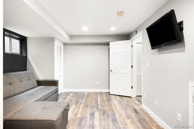 a view of a livingroom with wooden floor and flat screen tv