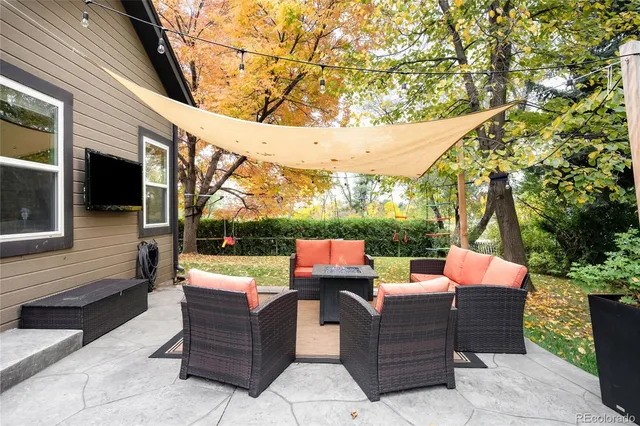 a view of a patio with couches chairs and a fire pit