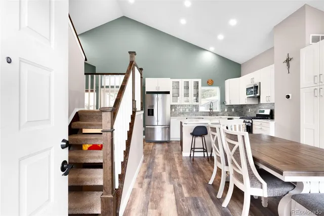 a view of kitchen with sink and wooden floor