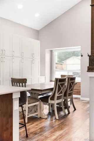 a view of a dining room with furniture and a window