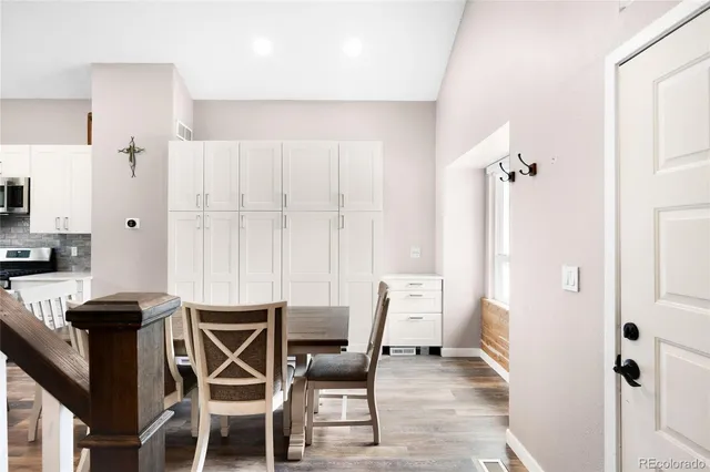 a view of a dining room with furniture and a chandelier