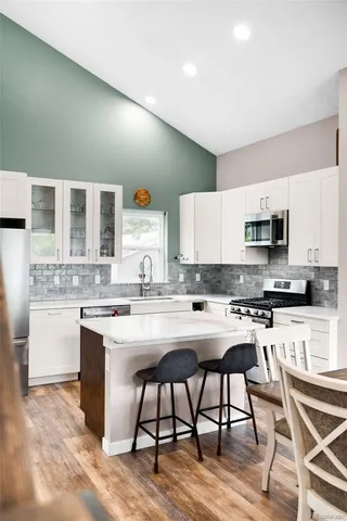 a kitchen with a sink a microwave and cabinets