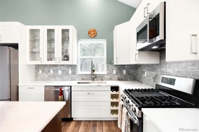 a kitchen with a stove a sink and a microwave