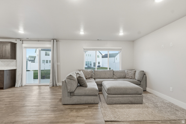 2011 Wren Circle Logan, UT 84339 - Photo 7 of 20 Living room with light wood-style floors and baseboards