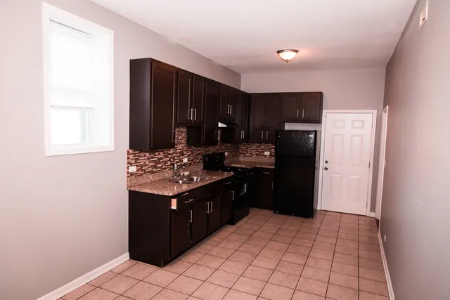 a kitchen with a refrigerator and a stove