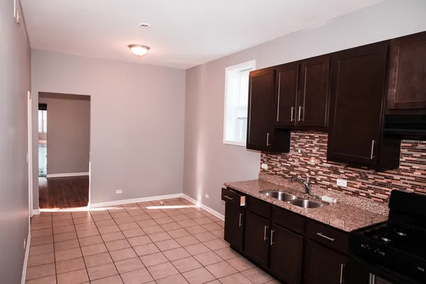 a kitchen with a sink and cabinets