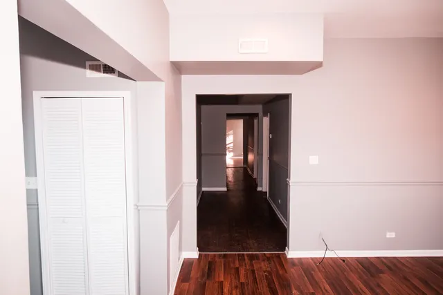 a view of a hallway view with wooden floor and staircase