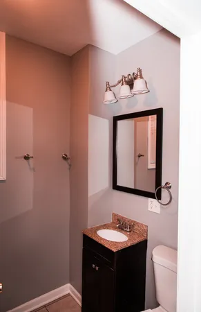 a bathroom with a toilet sink and mirror